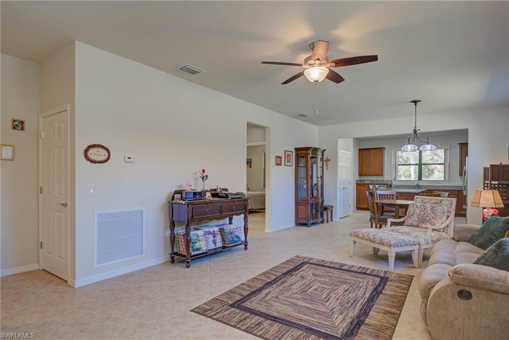5211 Ciatto Way Ave Maria, FL 34142 - Photo 3 of 31 a living room with furniture and a chandelier