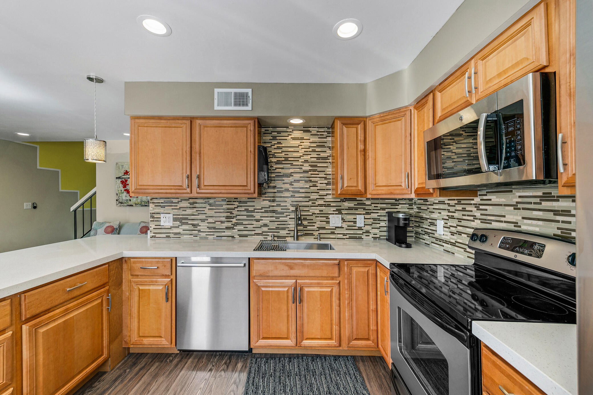 6025 Arroyo Road, Unit 7 Palm Springs, CA 92264 - Photo 16 of 43 a kitchen with stainless steel appliances granite countertop wooden cabinets stove top oven and sink