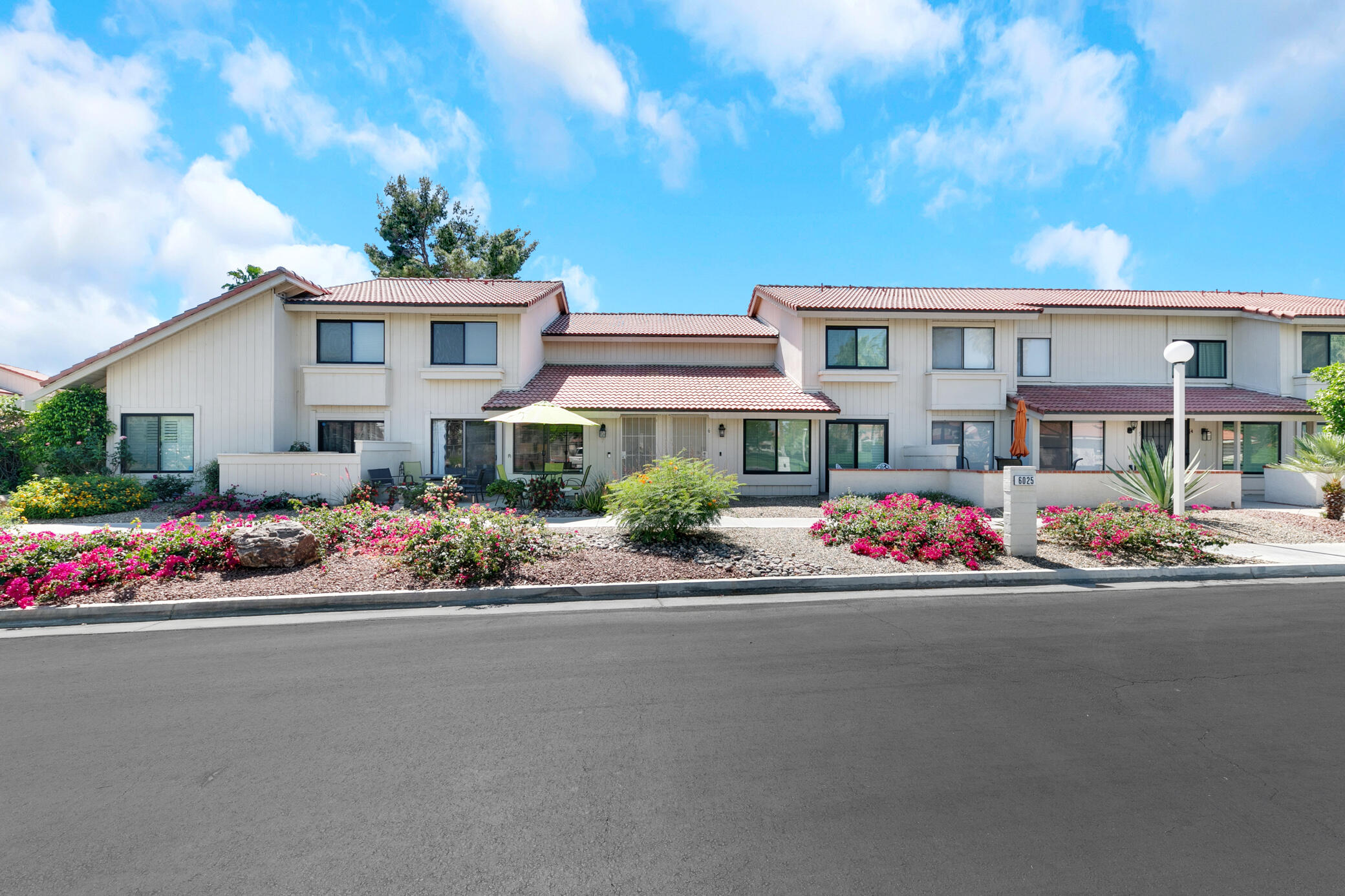 6025 Arroyo Road, Unit 7 Palm Springs, CA 92264 - Photo 2 of 43 a front view of a house with a yard