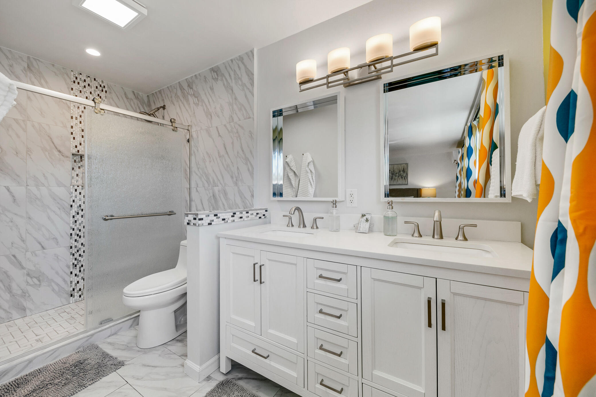 6025 Arroyo Road, Unit 7 Palm Springs, CA 92264 - Photo 24 of 43 a bathroom with a double vanity sink toilet and a mirror