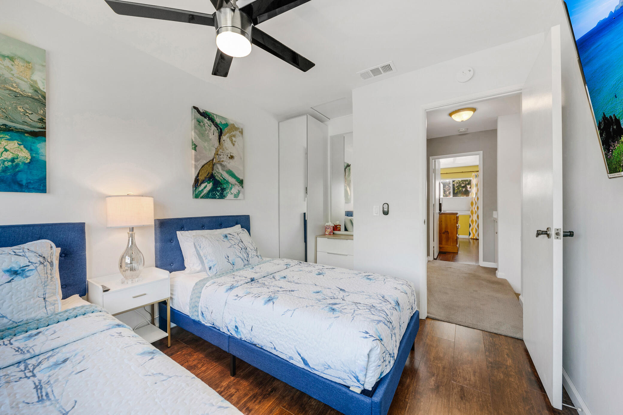 6025 Arroyo Road, Unit 7 Palm Springs, CA 92264 - Photo 26 of 43 a bedroom with a large bed and a chandelier