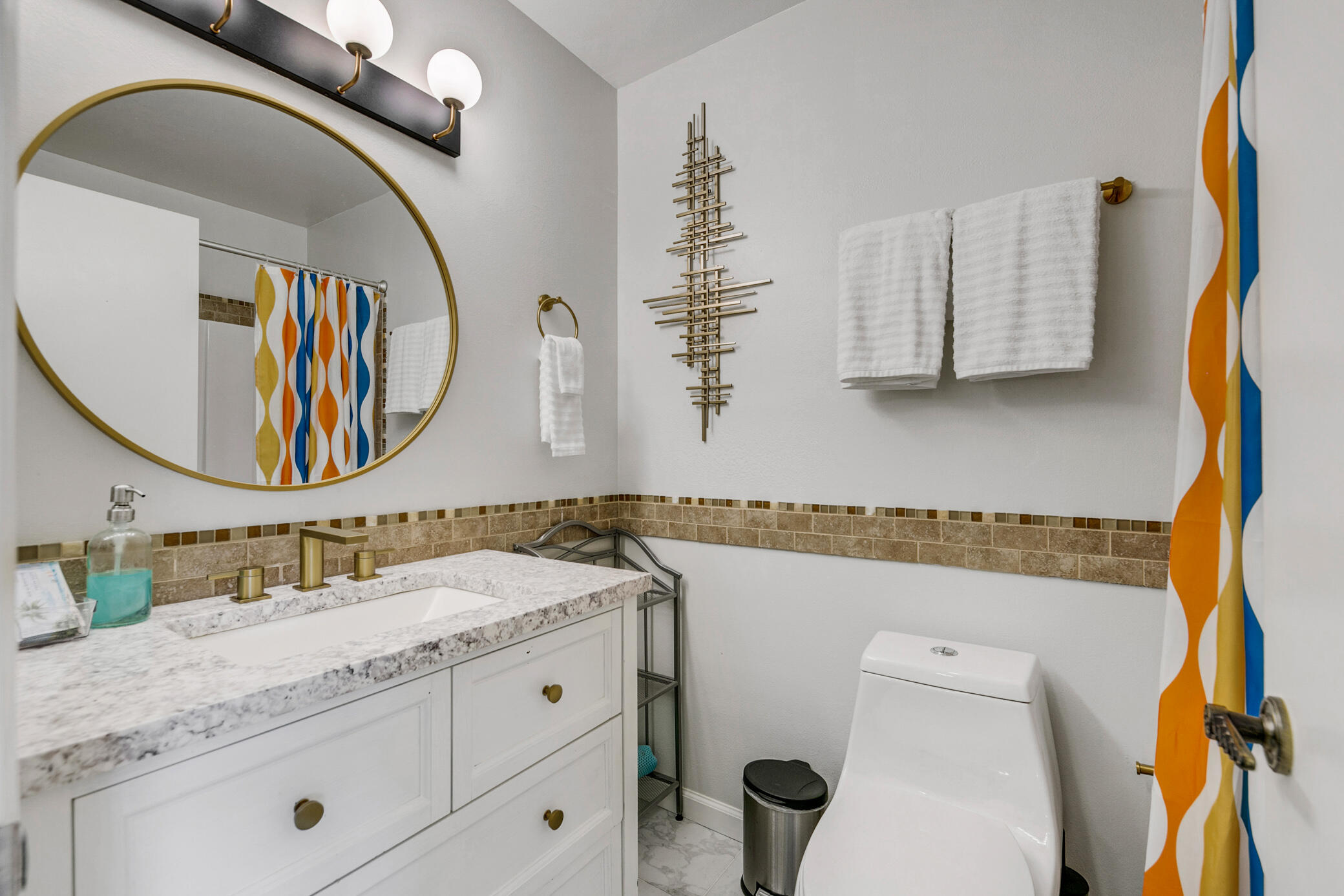 6025 Arroyo Road, Unit 7 Palm Springs, CA 92264 - Photo 27 of 43 a bathroom with a granite countertop sink mirror vanity and toilet