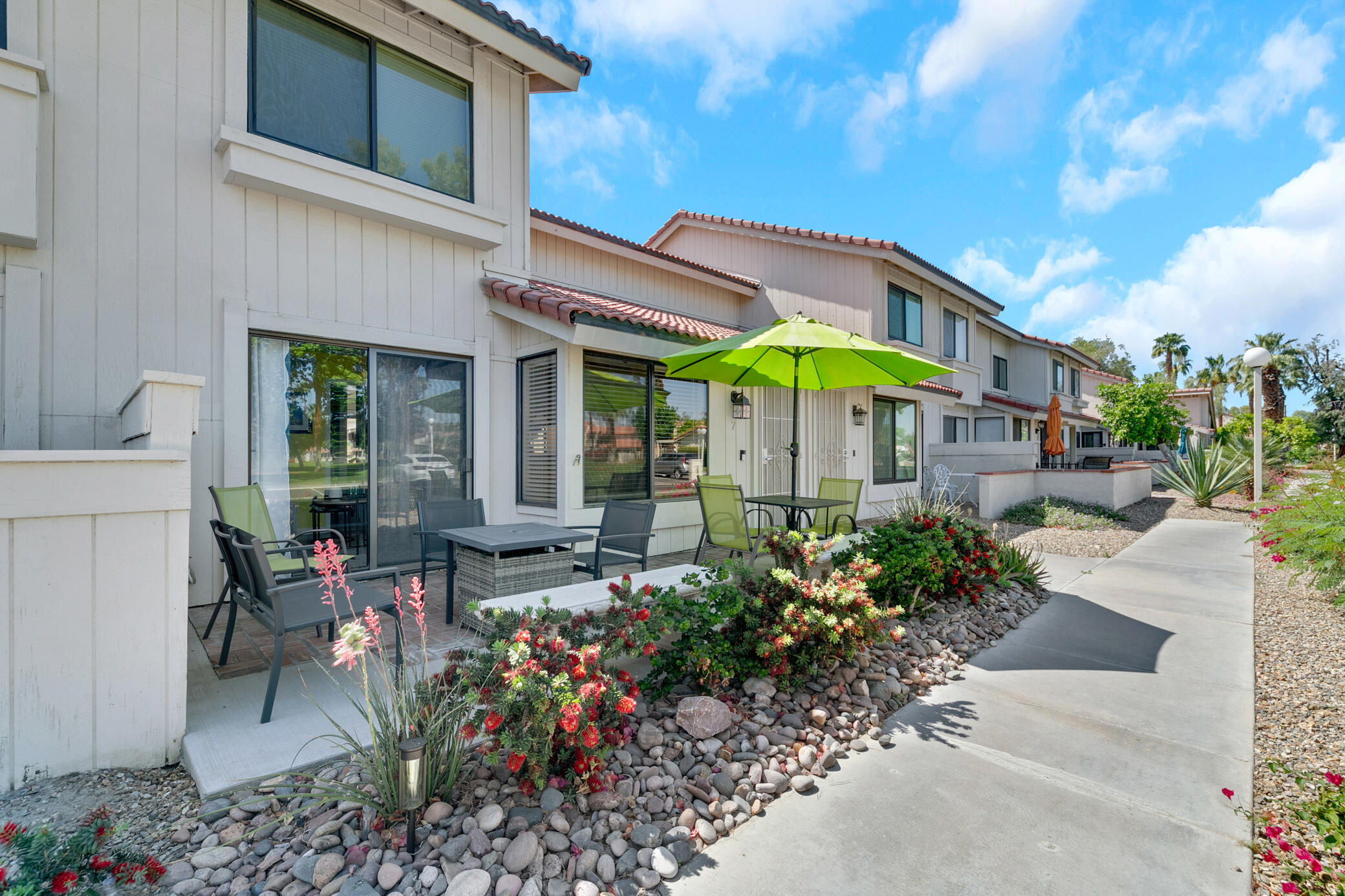 6025 Arroyo Road, Unit 7 Palm Springs, CA 92264 - Photo 3 of 43 a view of a patio with chairs and potted plants