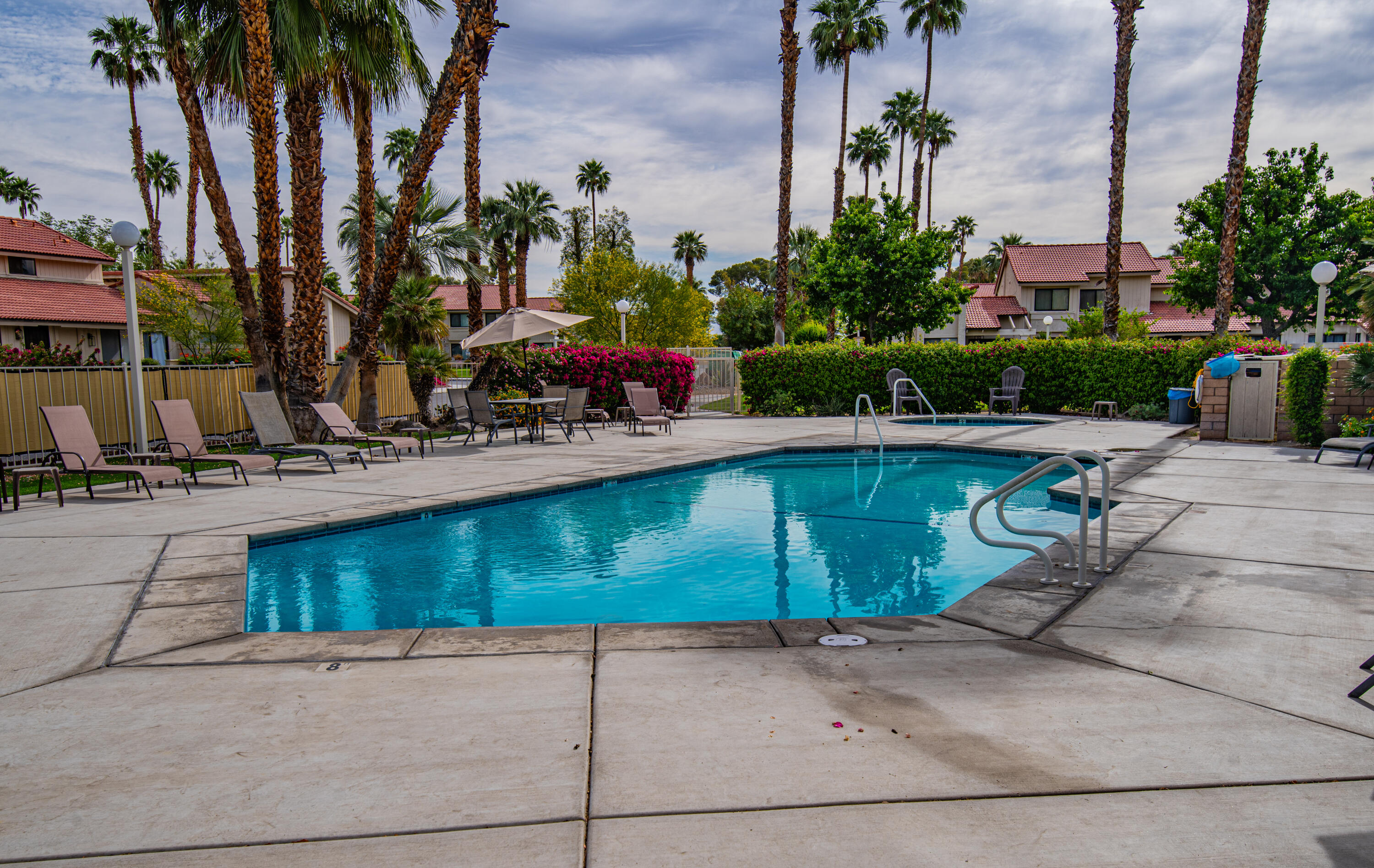 6025 Arroyo Road, Unit 7 Palm Springs, CA 92264 - Photo 32 of 43 a view of a swimming pool with a patio