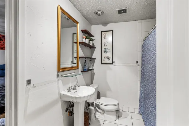 a bathroom with a sink toilet and mirror