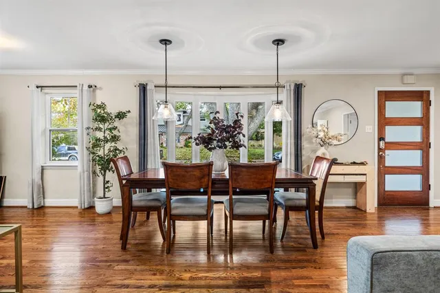 a view of a dining room with furniture window and wooden floor