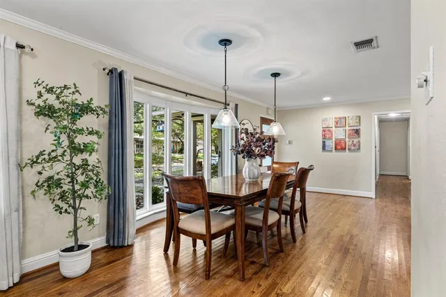 a dining room with furniture and wooden floor