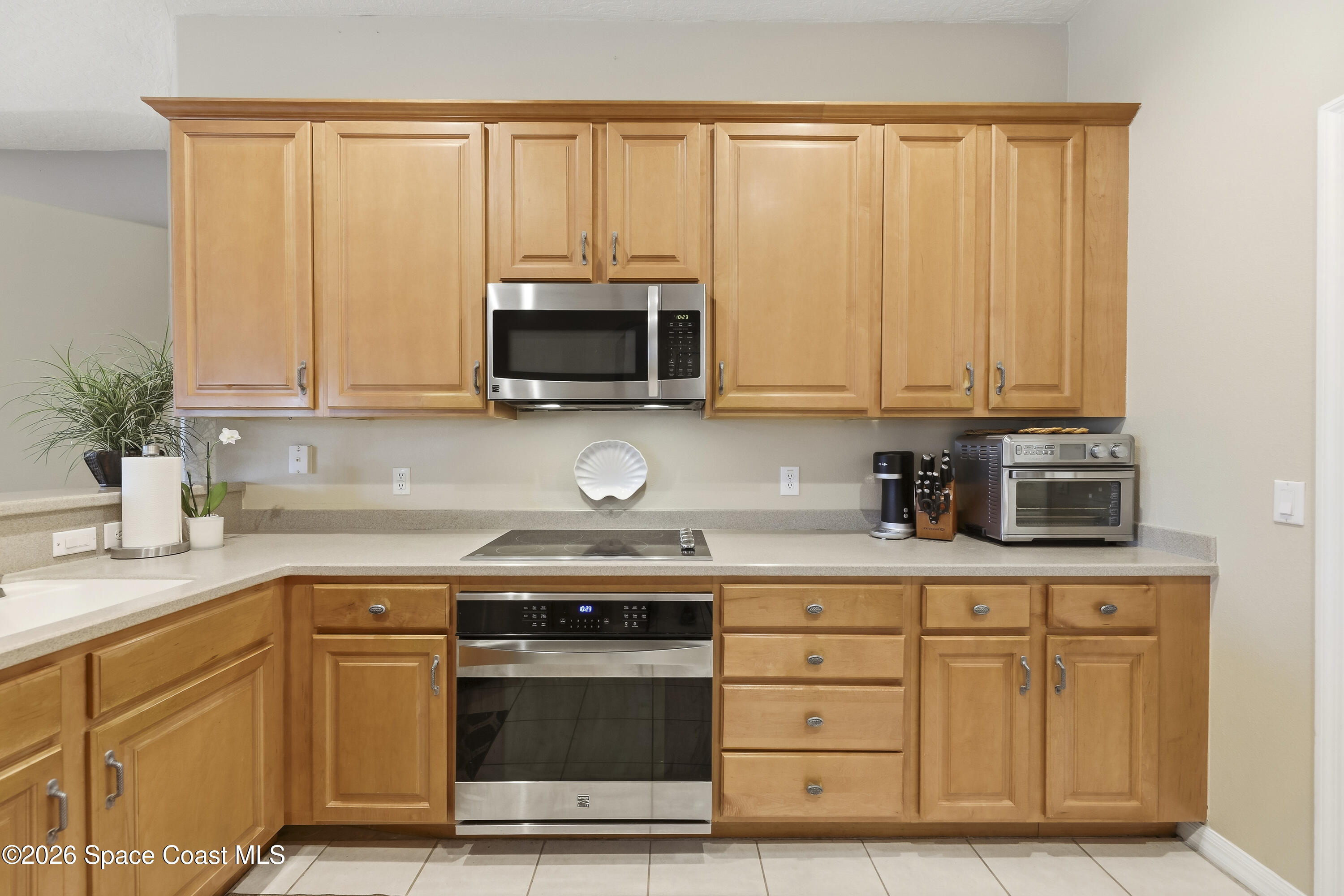 1643 Long Pine Road Melbourne, FL 32940 - Photo 20 of 63 a kitchen with stainless steel appliances granite countertop a stove a microwave and cabinets