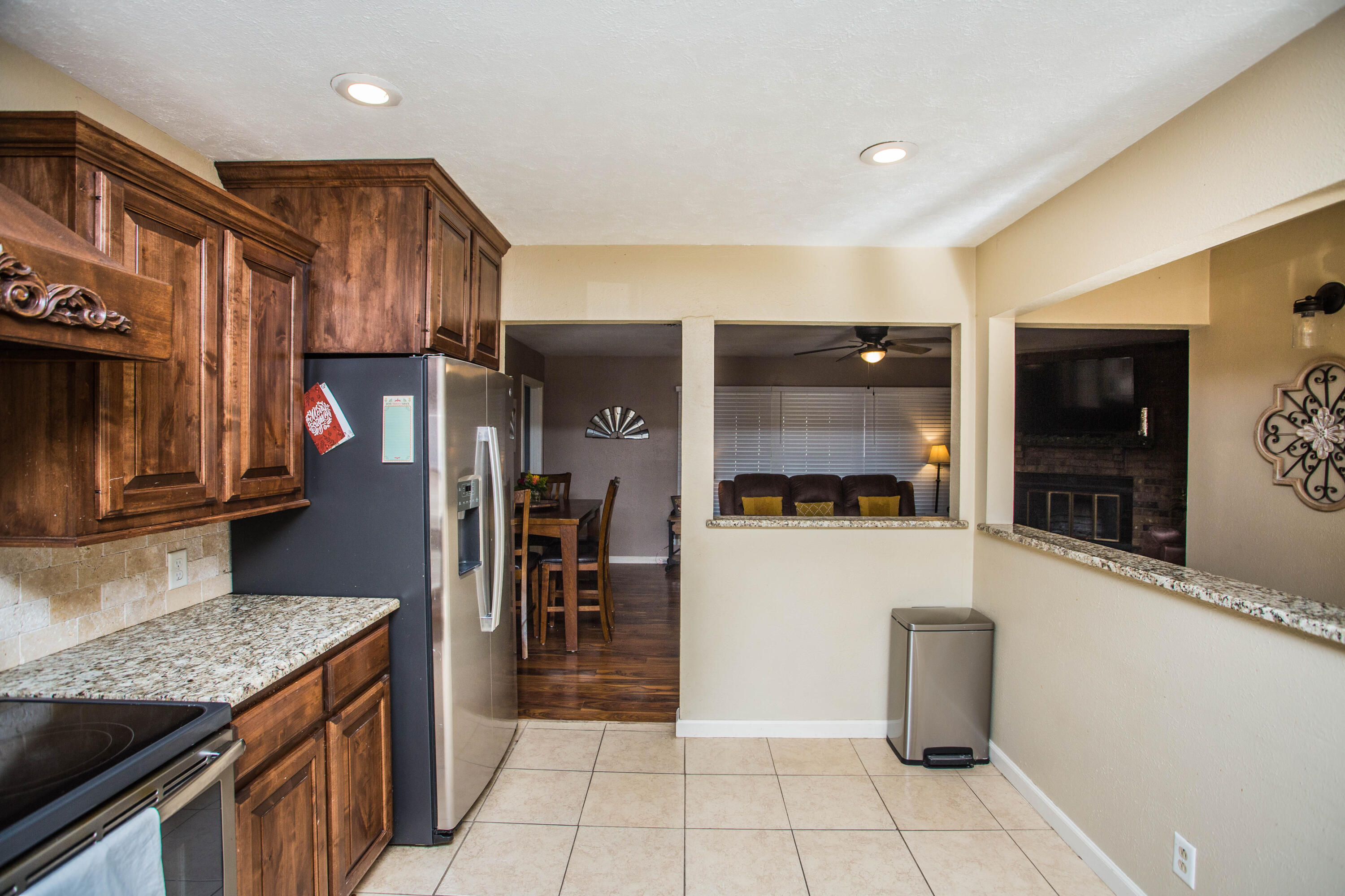 1550 West Lynn Street Slaton, TX 79364 - Photo 13 of 54 a kitchen with stainless steel appliances granite countertop a refrigerator and a stove