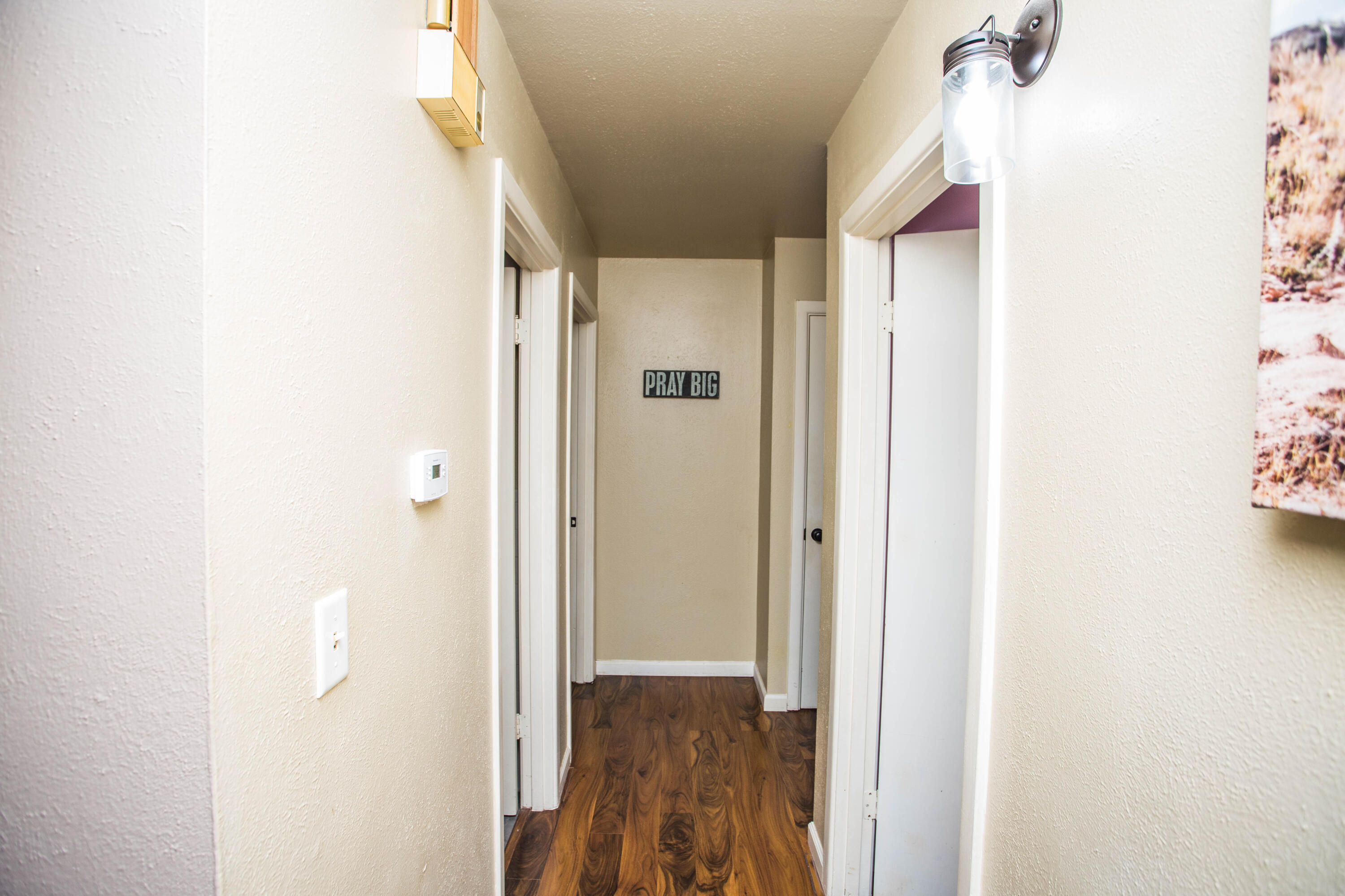 1550 West Lynn Street Slaton, TX 79364 - Photo 19 of 54 a view of a hallway with wooden floor