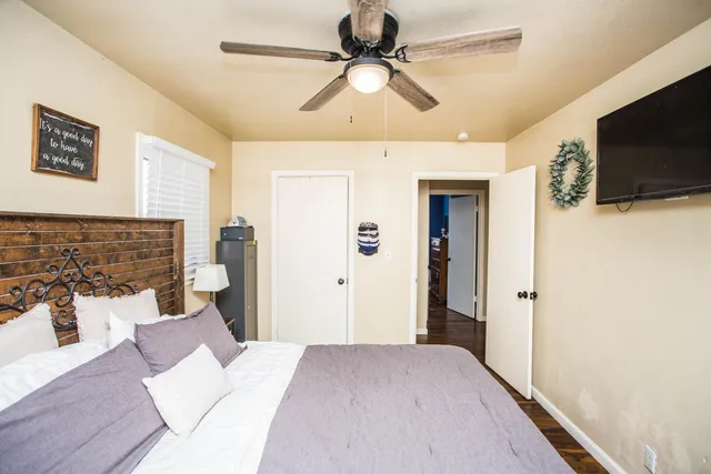 a bedroom with a bed and a flat screen tv