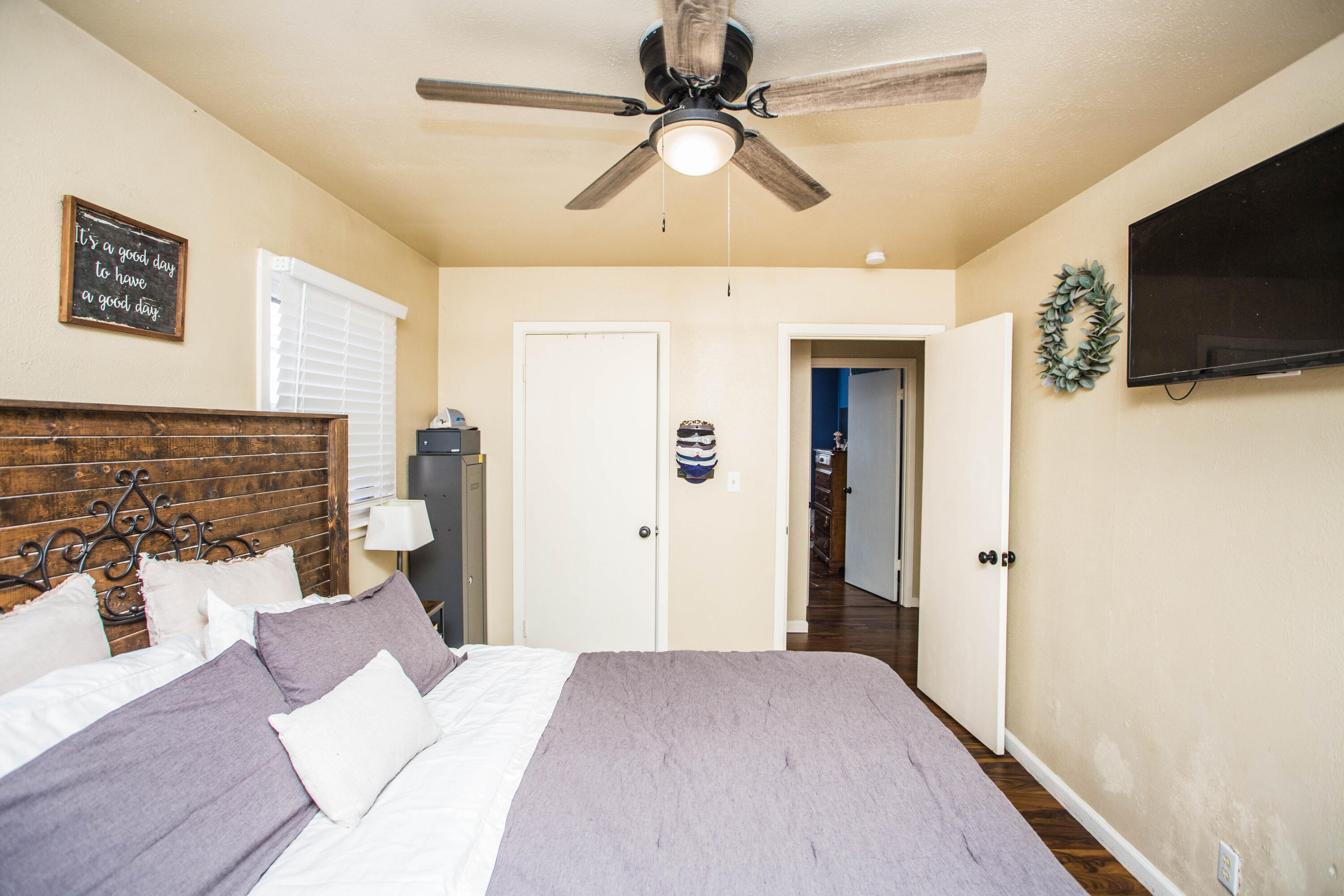 1550 West Lynn Street Slaton, TX 79364 - Photo 20 of 54 a bedroom with a bed and a flat screen tv