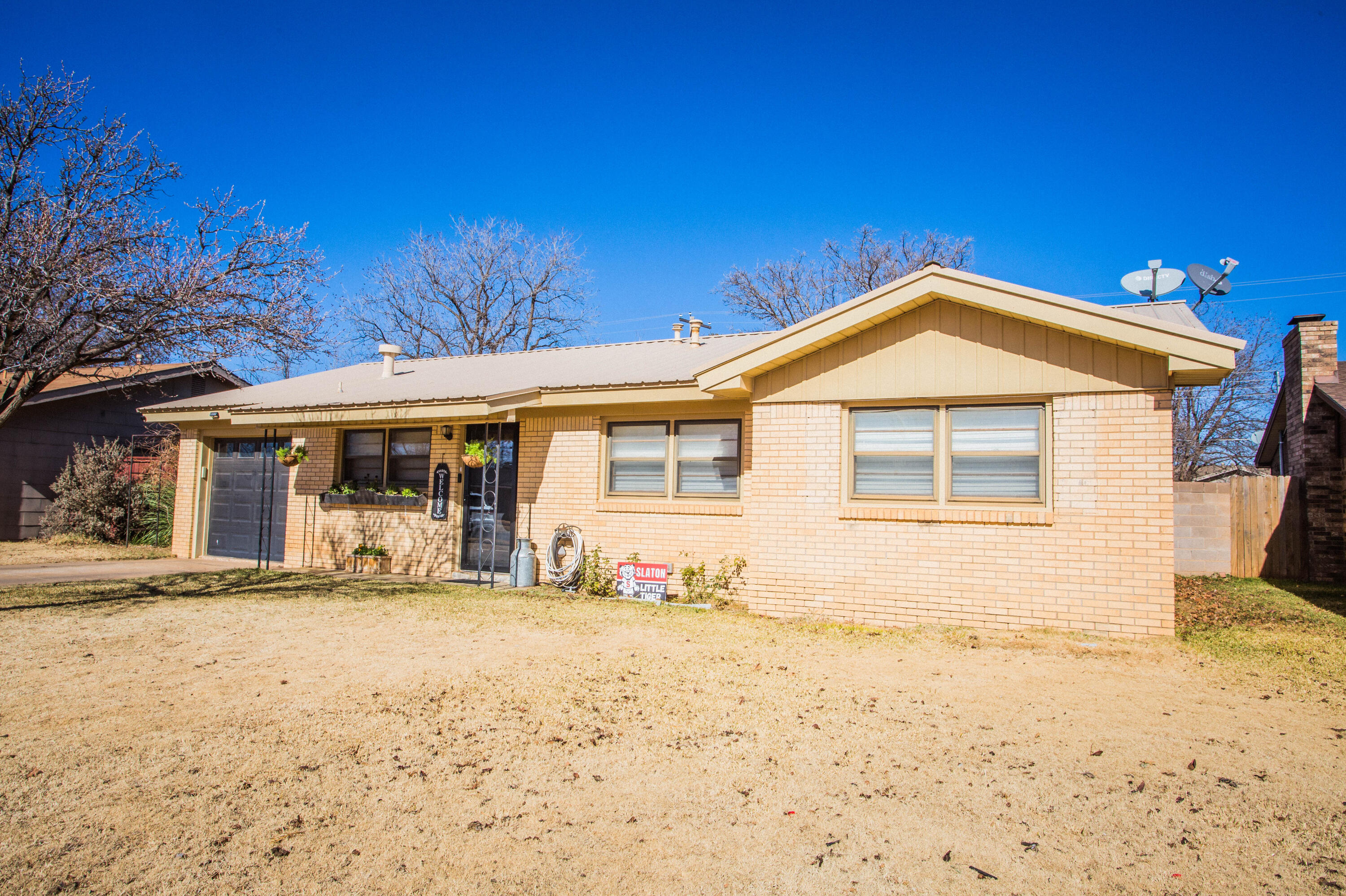 1550 West Lynn Street Slaton, TX 79364 - Photo 2 of 54 a front view of a house with a yard