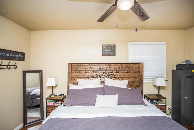 a bedroom with a bed and a chandelier