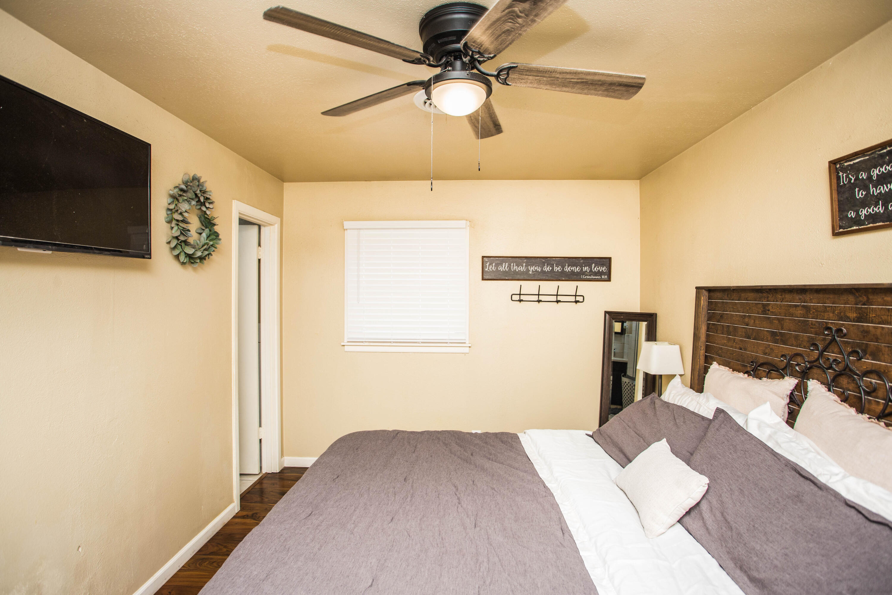 1550 West Lynn Street Slaton, TX 79364 - Photo 22 of 54 a bedroom with a bed and a flat screen tv