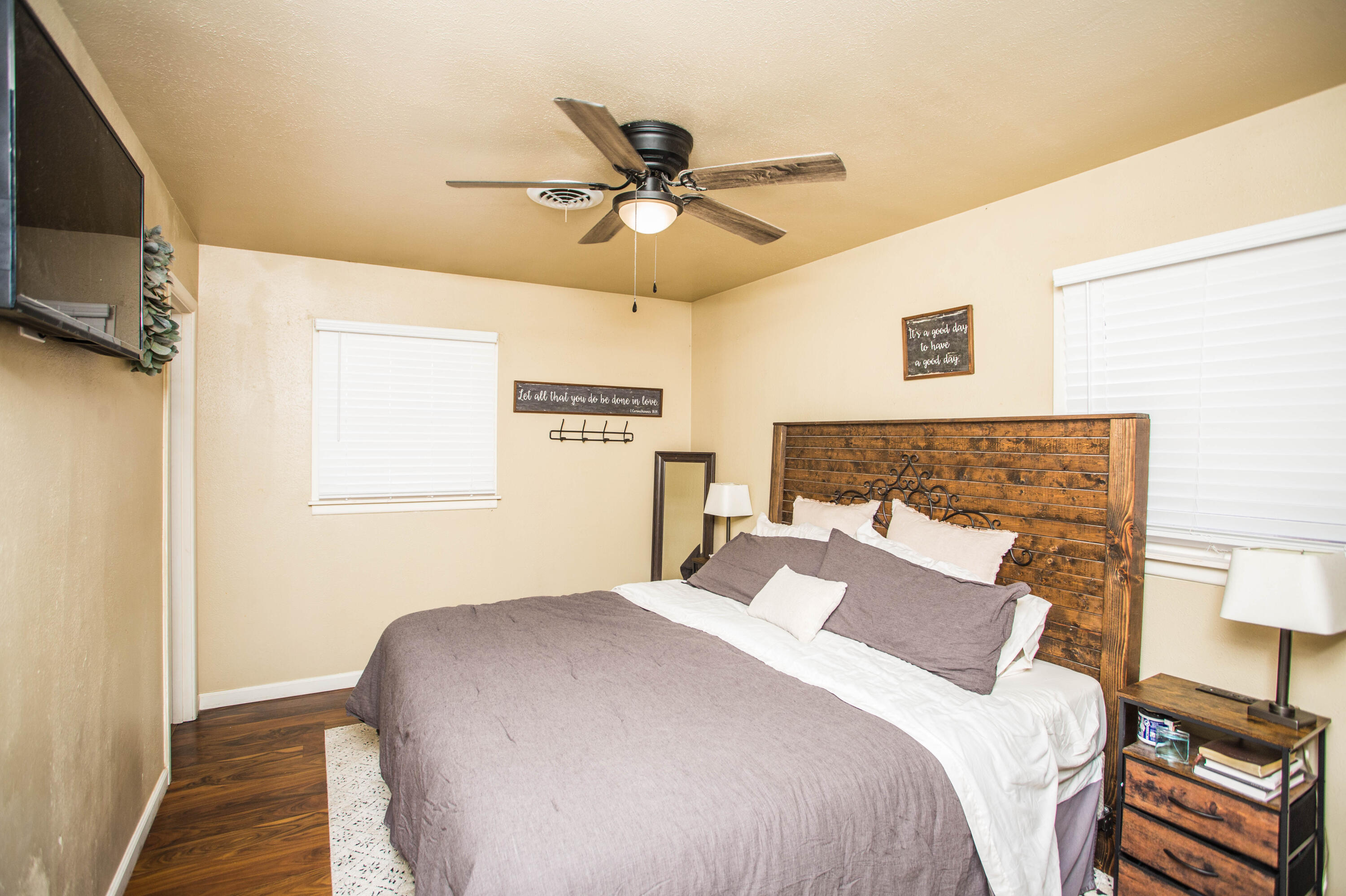 1550 West Lynn Street Slaton, TX 79364 - Photo 23 of 54 a bedroom with a bed and a chandelier