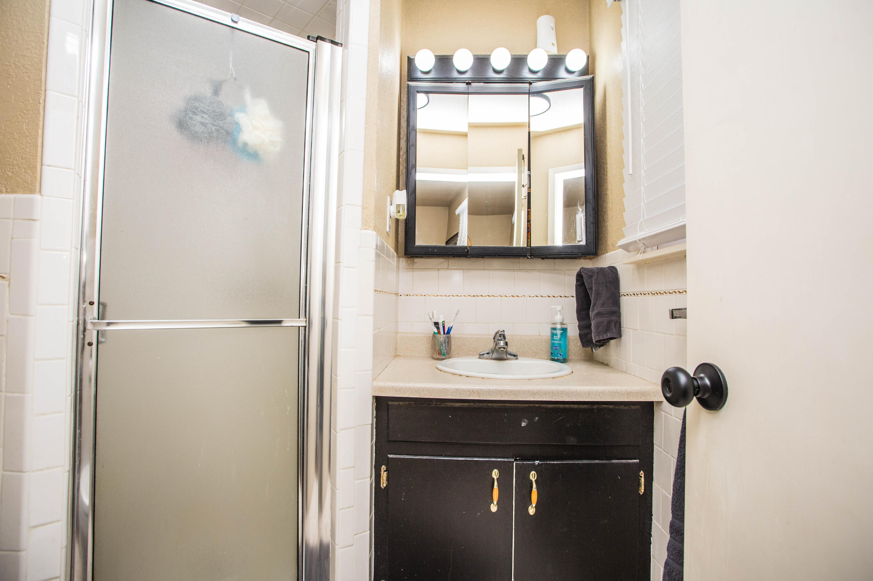 1550 West Lynn Street Slaton, TX 79364 - Photo 24 of 54 a bathroom with a sink and a mirror