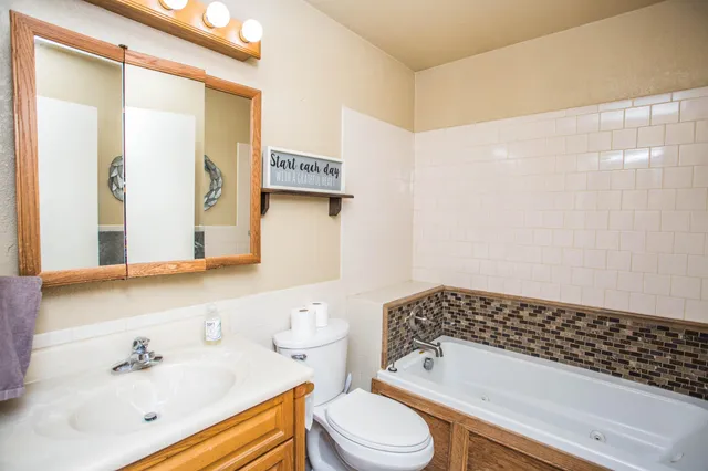 a bathroom with a sink a mirror and a shower