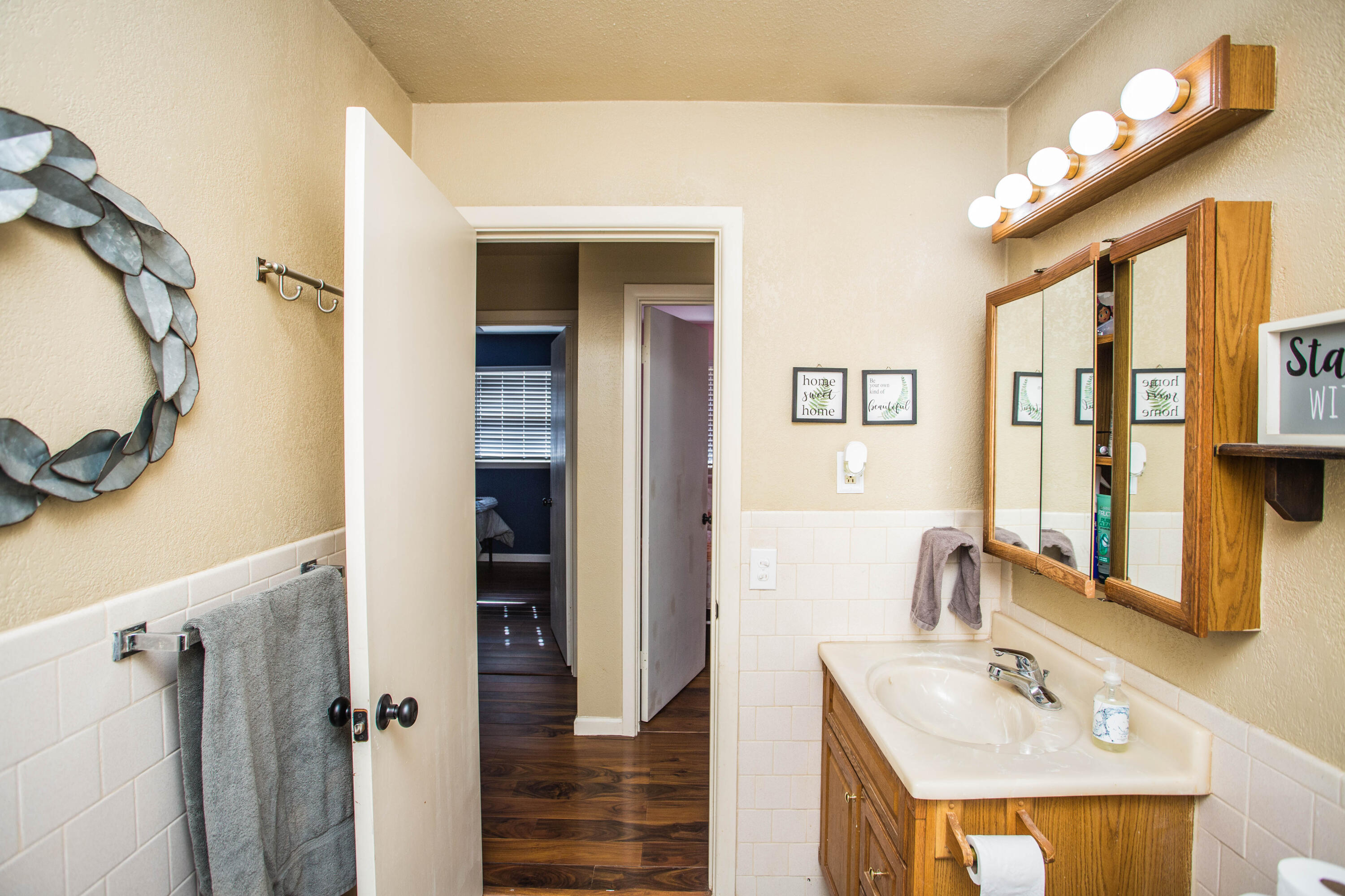 1550 West Lynn Street Slaton, TX 79364 - Photo 31 of 54 a bathroom with a sink a mirror and a shower