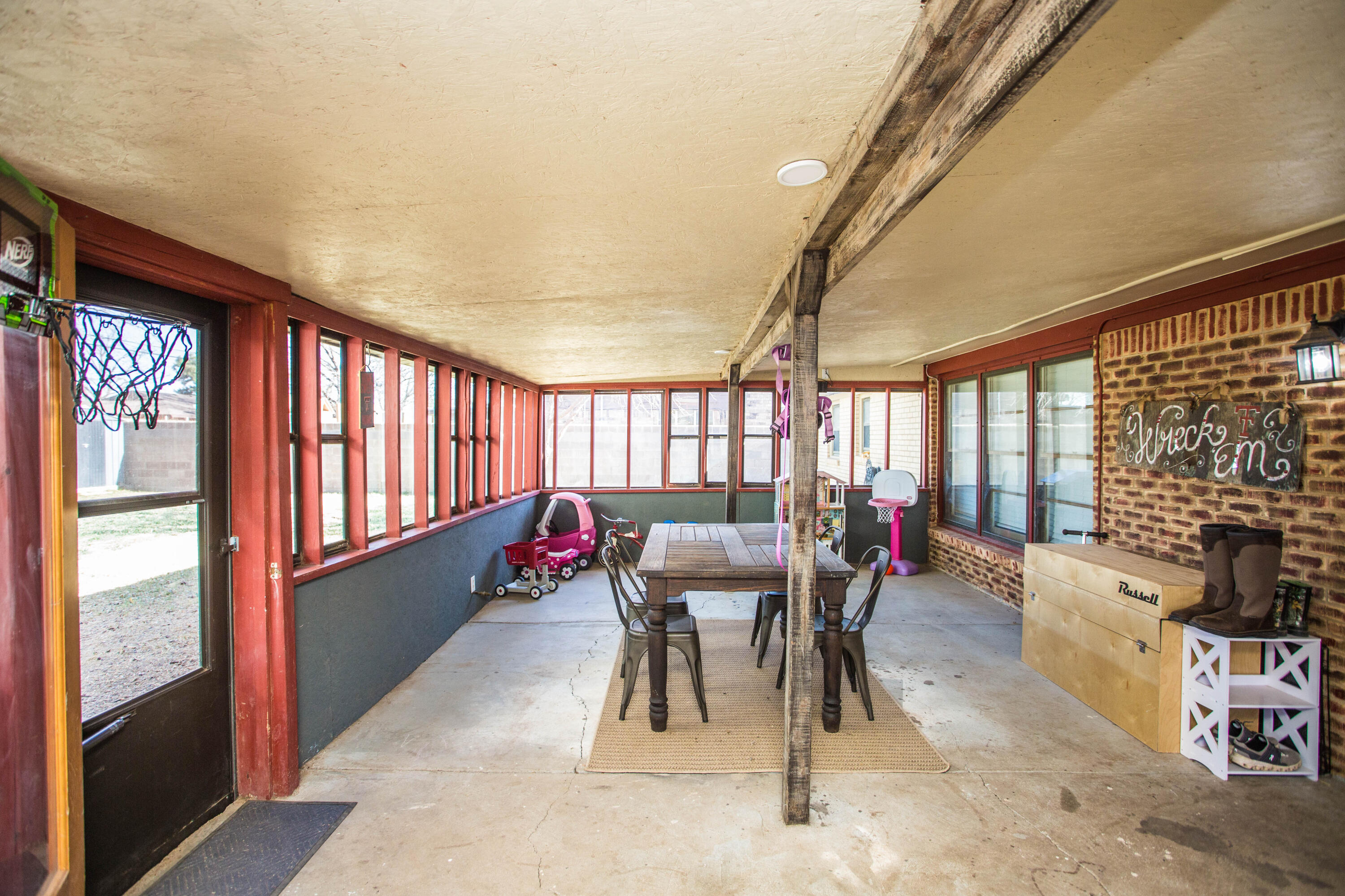 1550 West Lynn Street Slaton, TX 79364 - Photo 36 of 54 a view of a dining room with furniture wooden floor and a chandelier