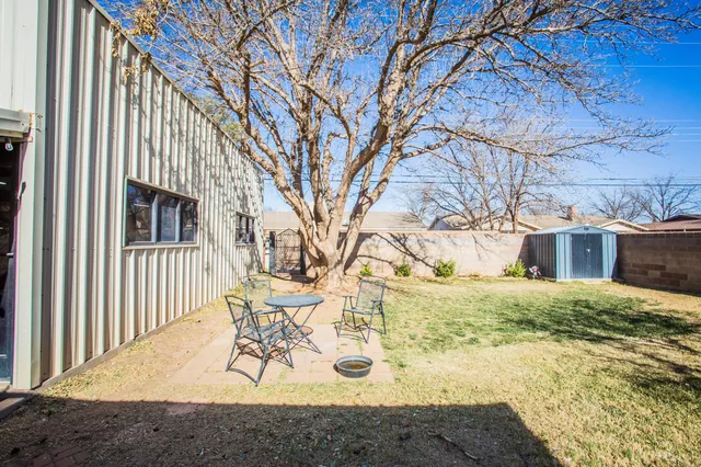 a view of a house with a yard covered in snow