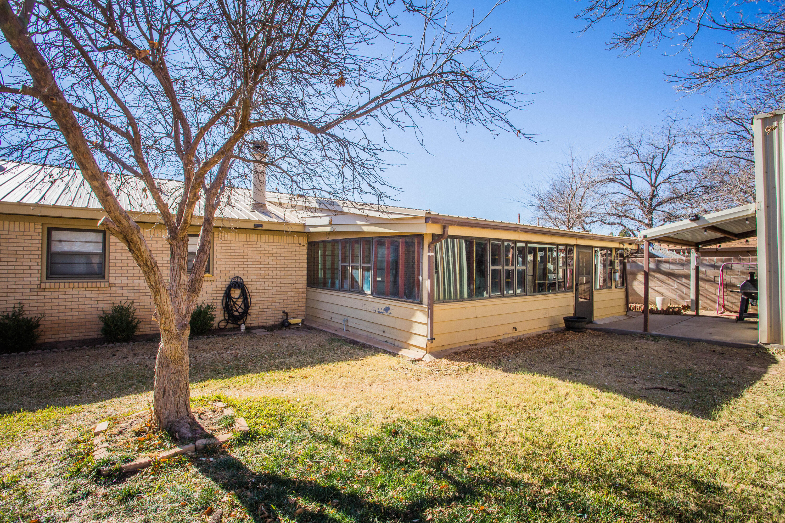 1550 West Lynn Street Slaton, TX 79364 - Photo 42 of 54 a view of a house with a yard covered in snow