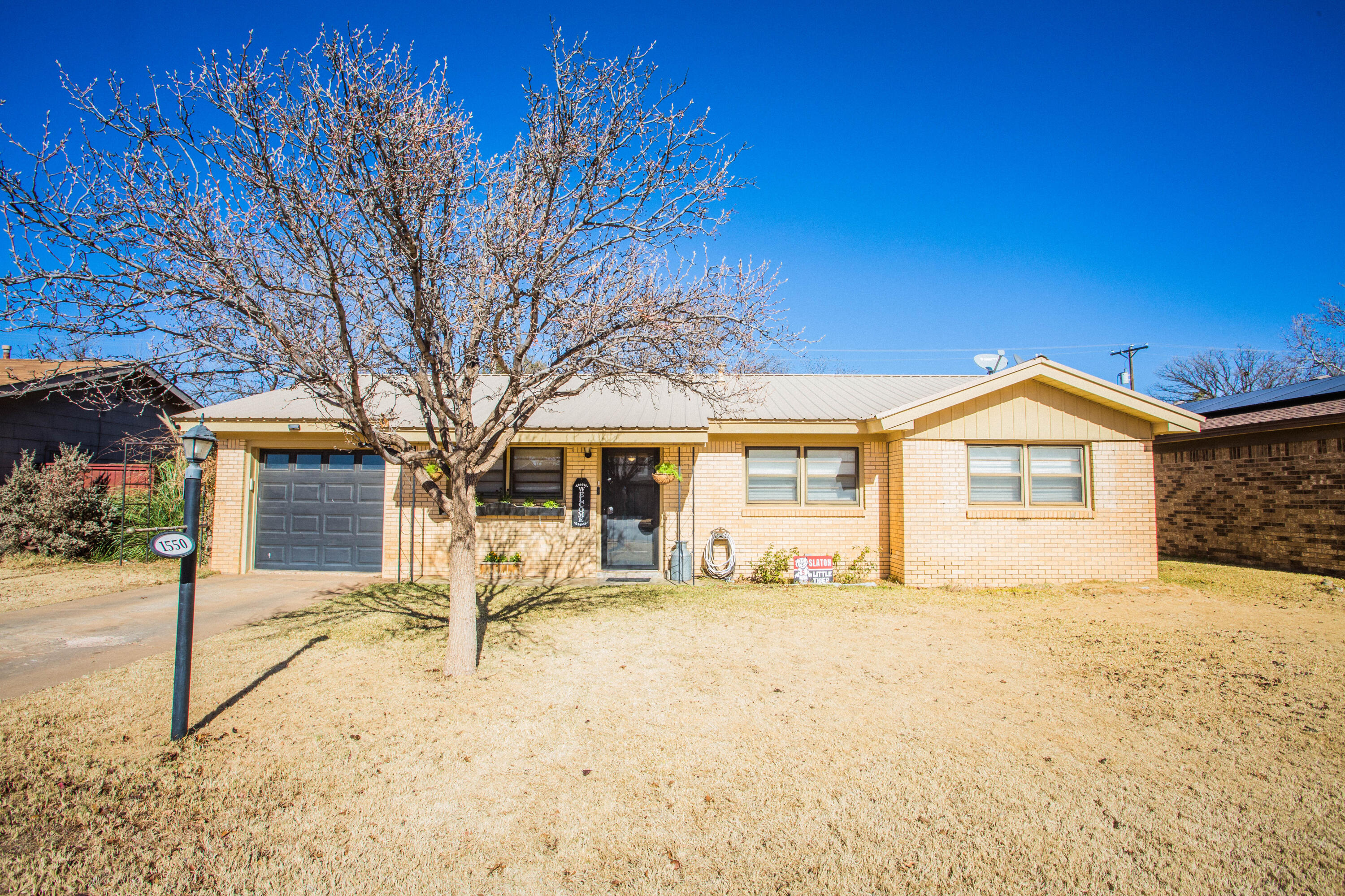 1550 West Lynn Street Slaton, TX 79364 - Photo 51 of 54 a view of a house with a yard covered in snow