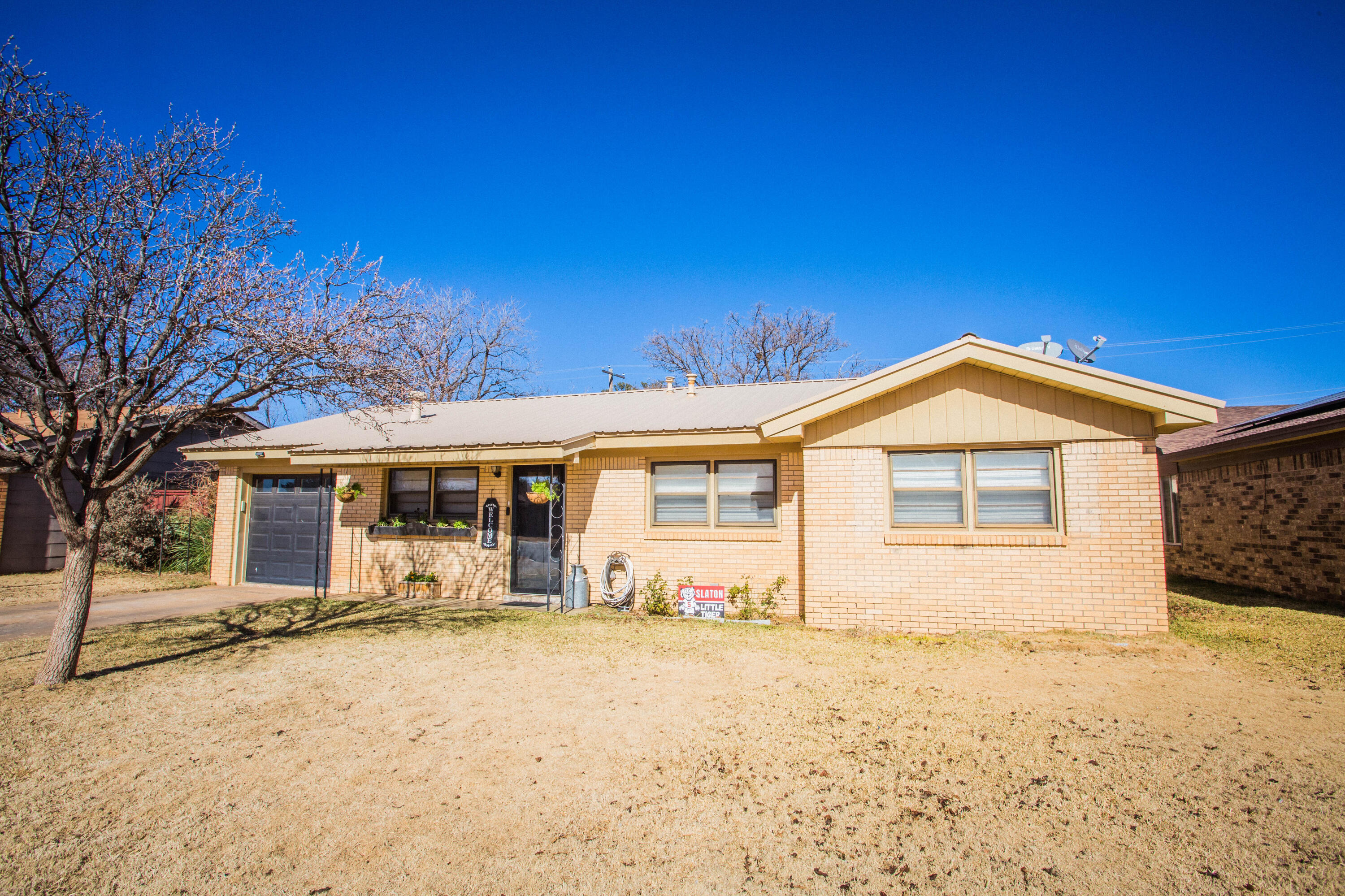 1550 West Lynn Street Slaton, TX 79364 - Photo 53 of 54 a front view of a house with a yard covered in snow