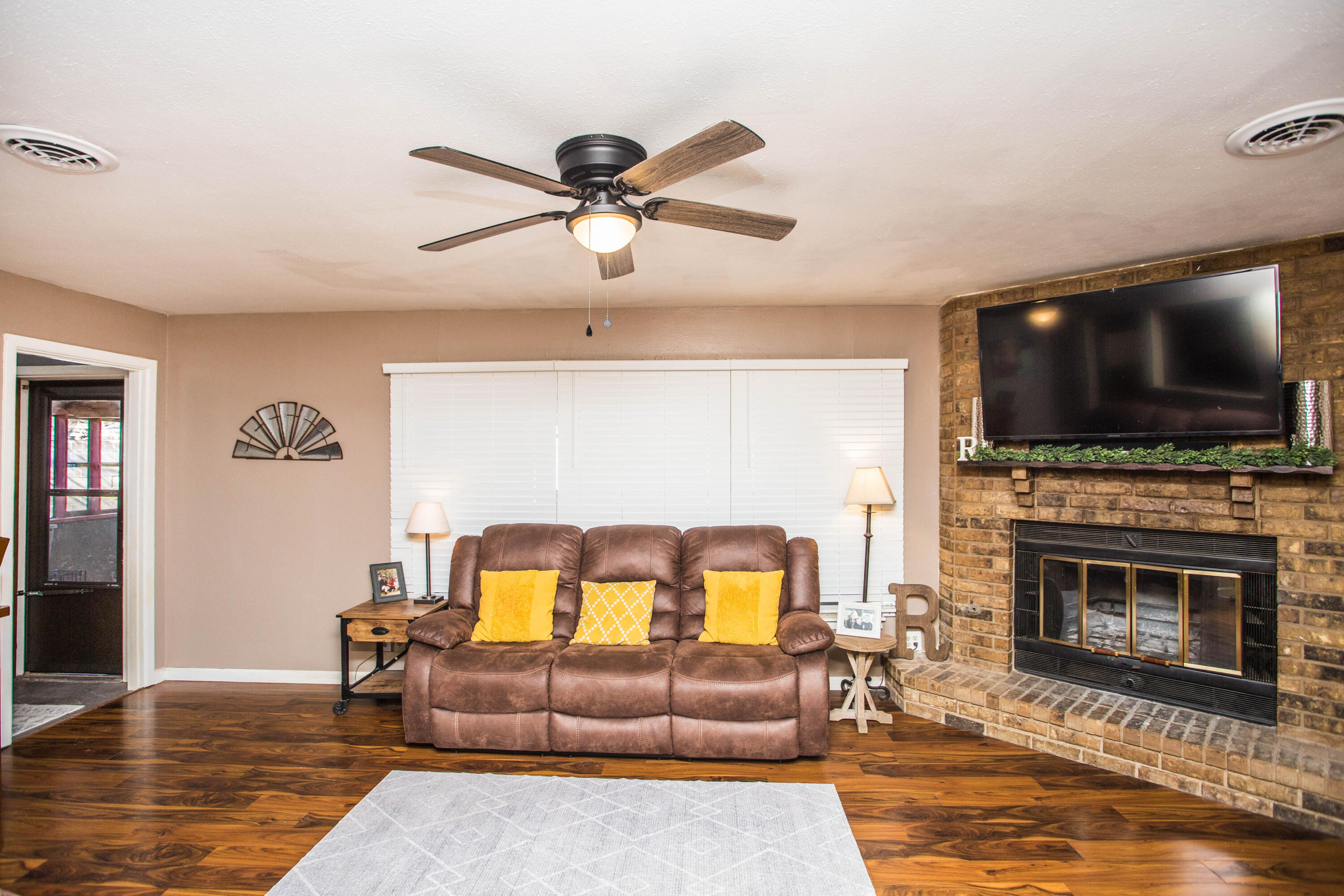 1550 West Lynn Street Slaton, TX 79364 - Photo 7 of 54 a living room with furniture and a flat screen tv