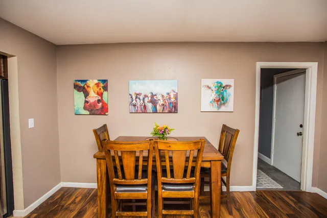 a view of a dining room with furniture and wooden floor