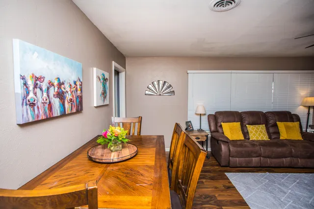 a living room with furniture and painting on the wall