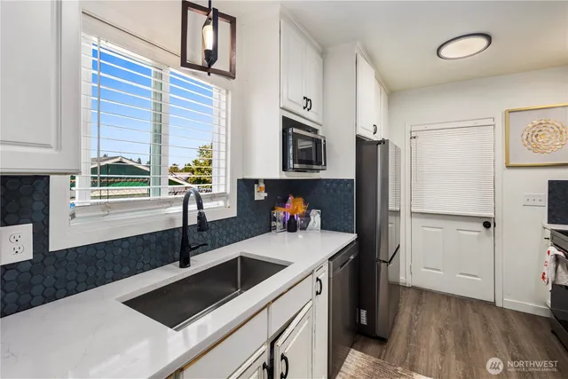 a kitchen with a refrigerator and a sink
