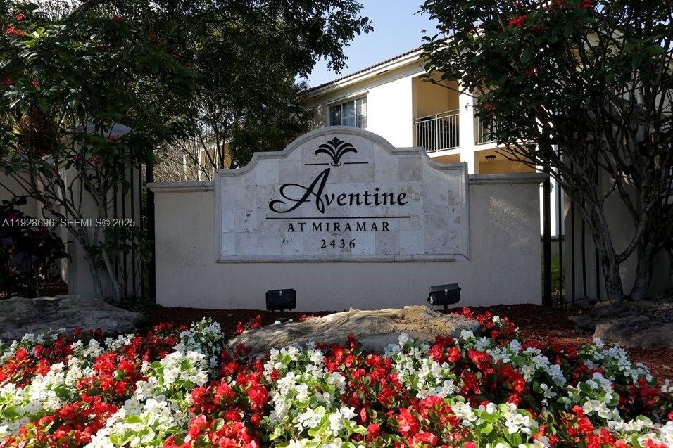 2406 Centergate Drive, Unit 201 Miramar, FL 33025 - Photo 1 of 41 a sign that is in front of flowers