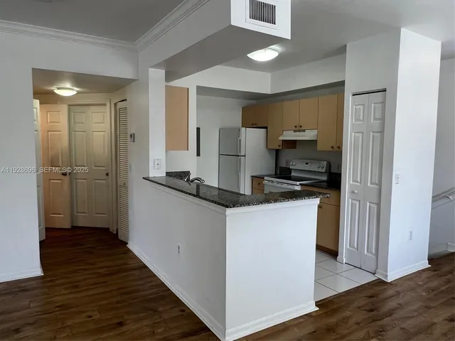 a kitchen with kitchen island a sink appliances and cabinets