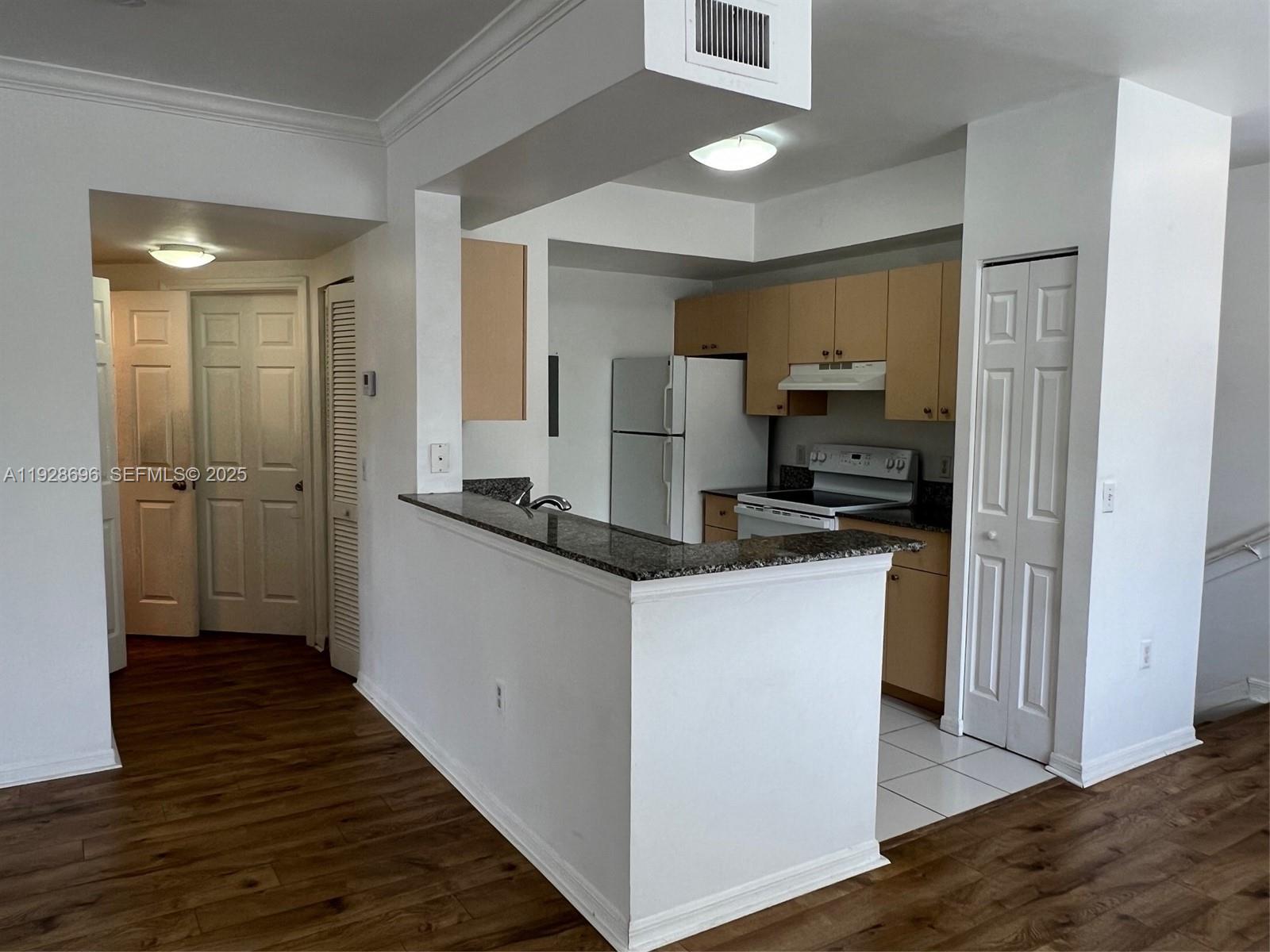 2406 Centergate Drive, Unit 201 Miramar, FL 33025 - Photo 13 of 41 a kitchen with kitchen island a sink appliances and cabinets