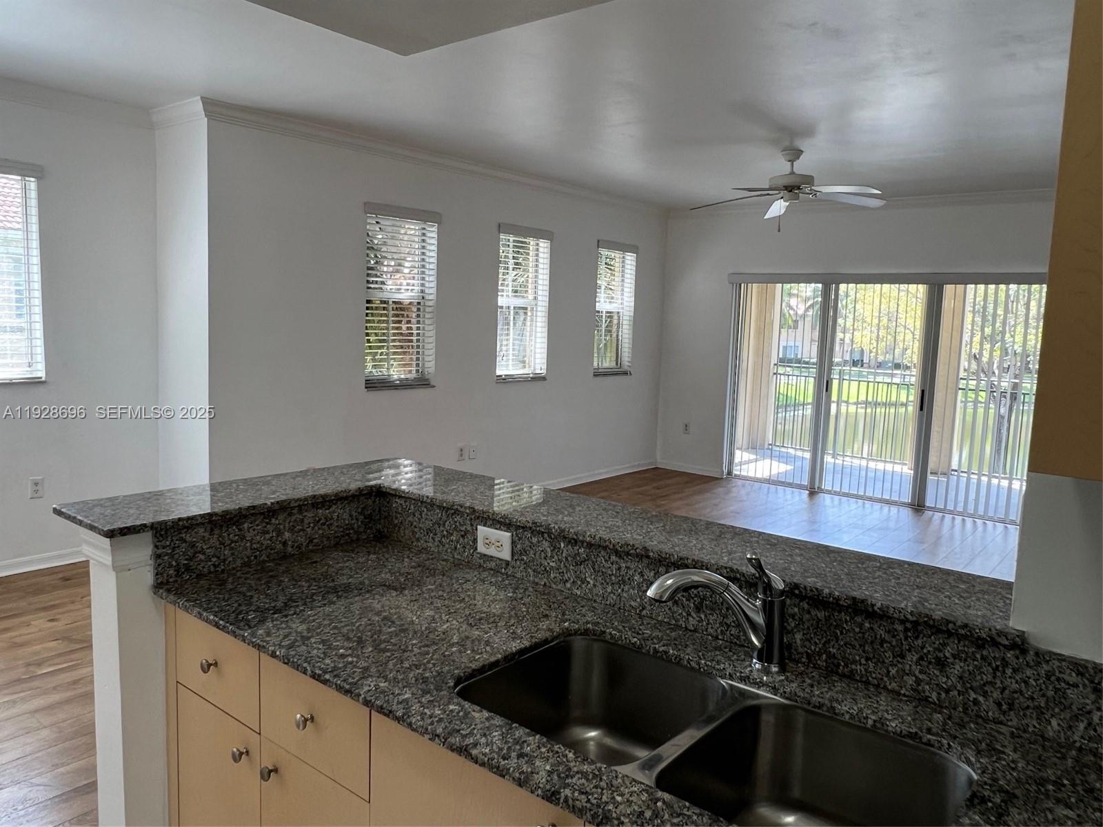 2406 Centergate Drive, Unit 201 Miramar, FL 33025 - Photo 14 of 41 a kitchen with a sink and cabinets