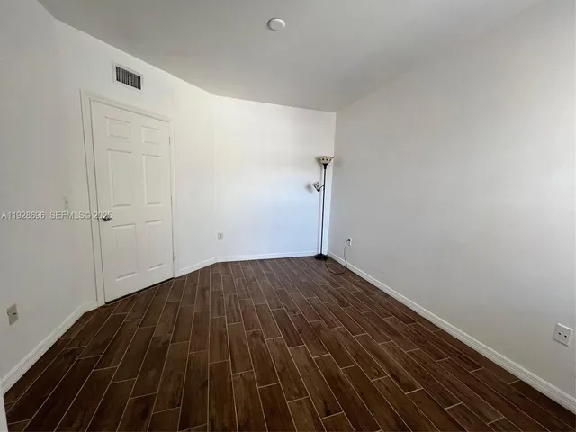 a view of a room with wooden floor