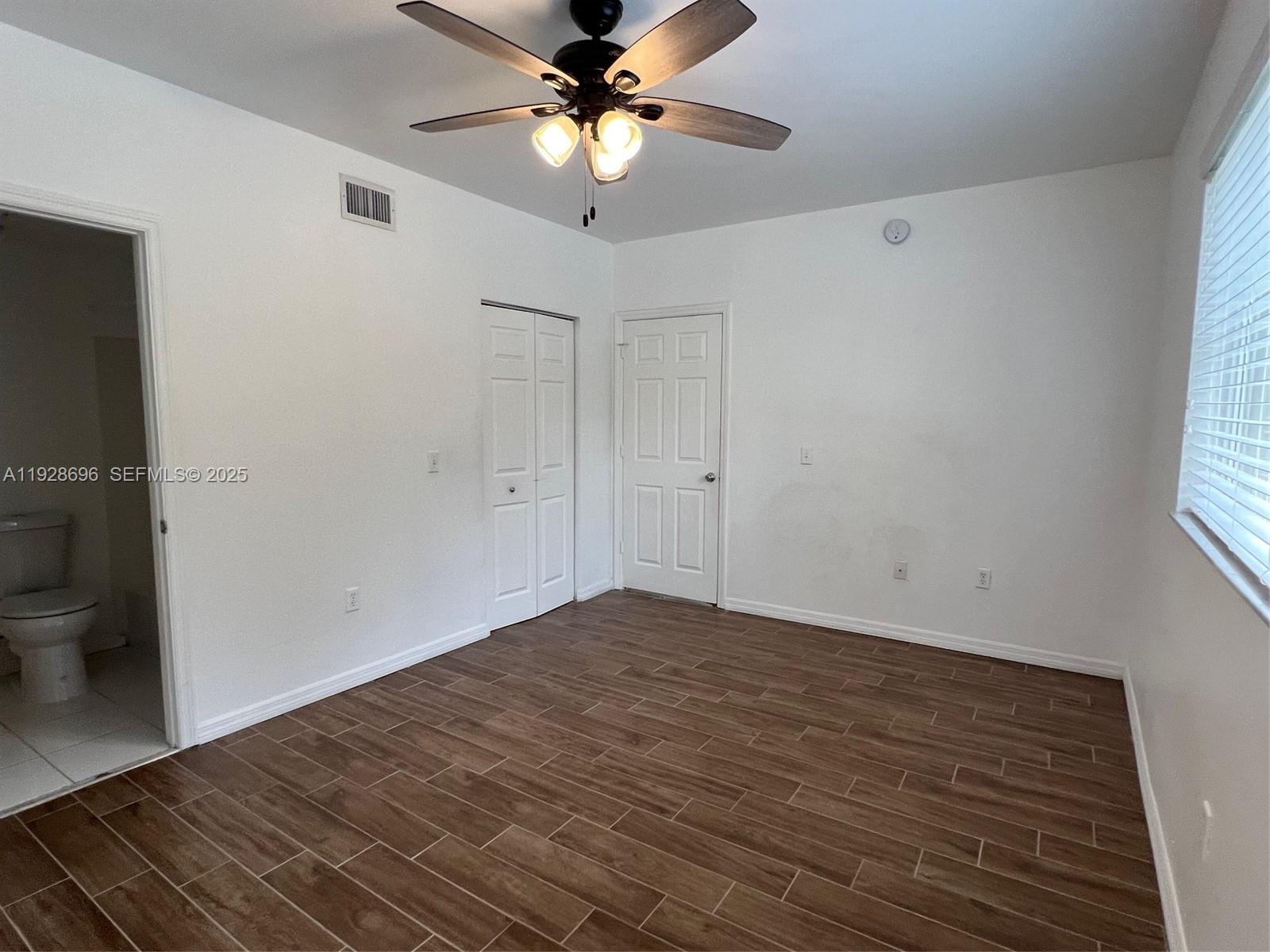 2406 Centergate Drive, Unit 201 Miramar, FL 33025 - Photo 21 of 41 wooden floor in an empty room with a window