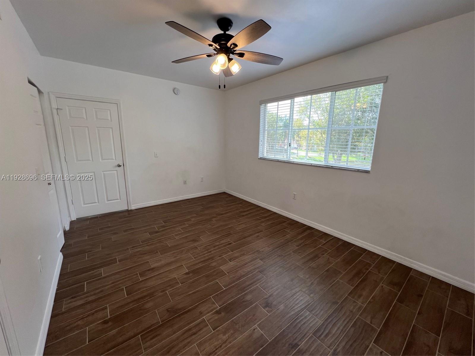 2406 Centergate Drive, Unit 201 Miramar, FL 33025 - Photo 22 of 41 a view of empty room with wooden floor and fan