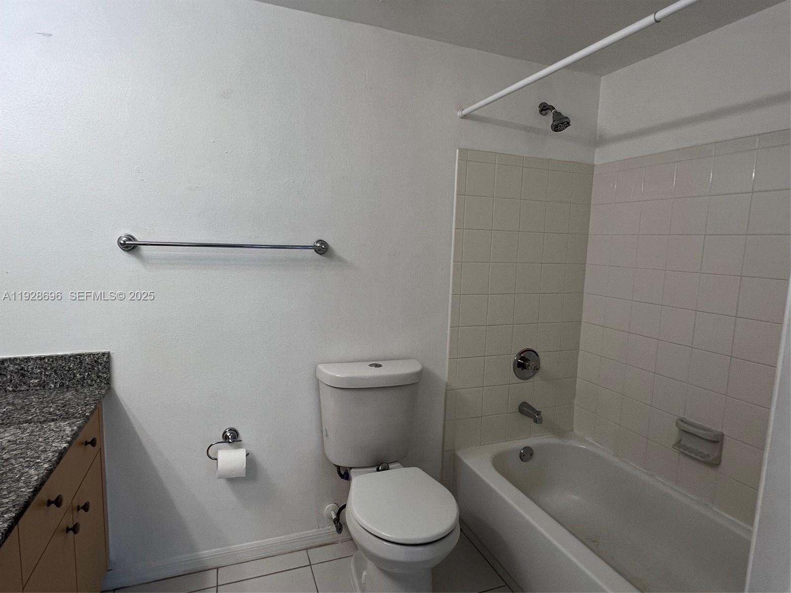 2406 Centergate Drive, Unit 201 Miramar, FL 33025 - Photo 25 of 41 a white toilet sitting next to a bath tub