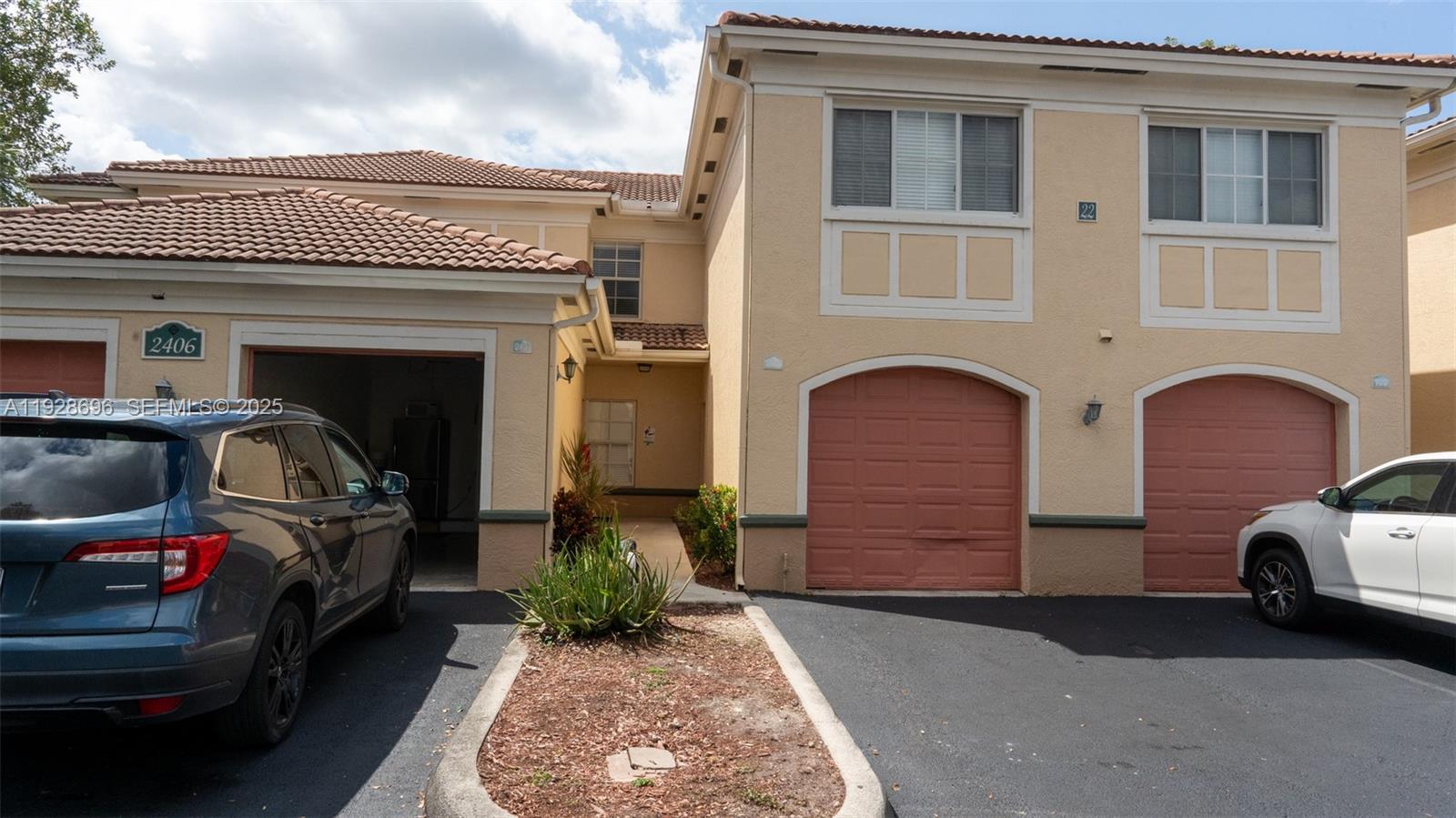 2406 Centergate Drive, Unit 201 Miramar, FL 33025 - Photo 3 of 41 a couple of cars parked in front of a house