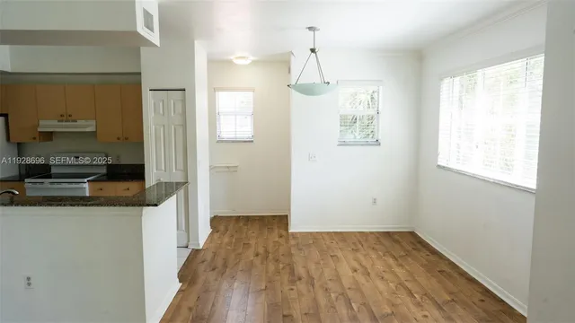 a view of a kitchen cabinets and wooden floor