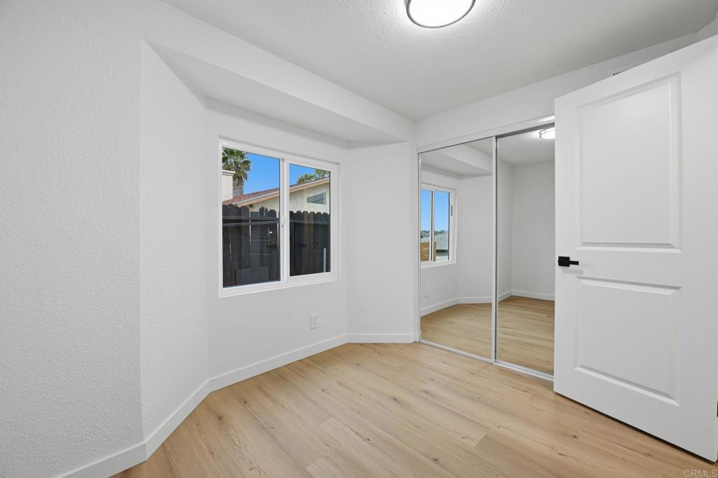1333 Helix Street Spring Valley, CA 91977 - Photo 32 of 45 an empty room with wooden floor and windows