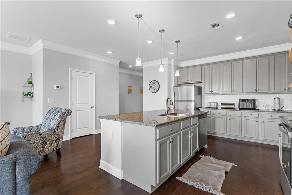 2787 Pearl Rdg Trace Buford, GA 30519 - Photo 23 of 52 a kitchen with stainless steel appliances kitchen island granite countertop a stove a sink and a refrigerator