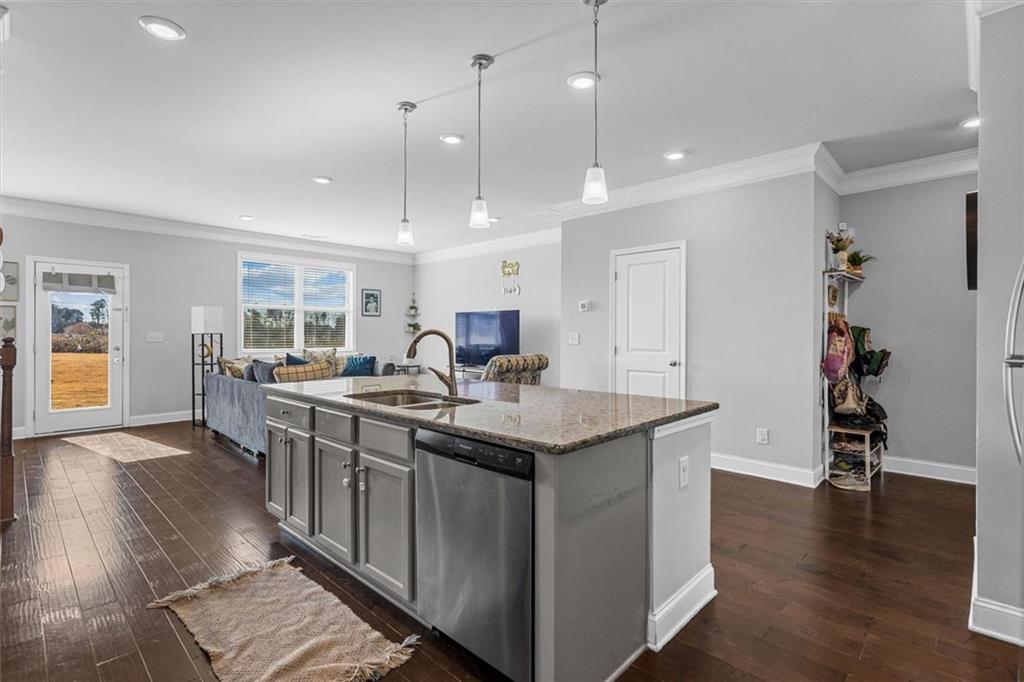 2787 Pearl Rdg Trace Buford, GA 30519 - Photo 24 of 52 a kitchen with stainless steel appliances granite countertop a stove and a wooden floors