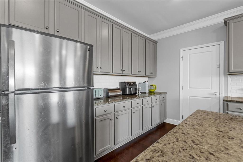 2787 Pearl Rdg Trace Buford, GA 30519 - Photo 26 of 52 a kitchen with stainless steel appliances granite countertop a refrigerator a sink and white cabinets with wooden floor
