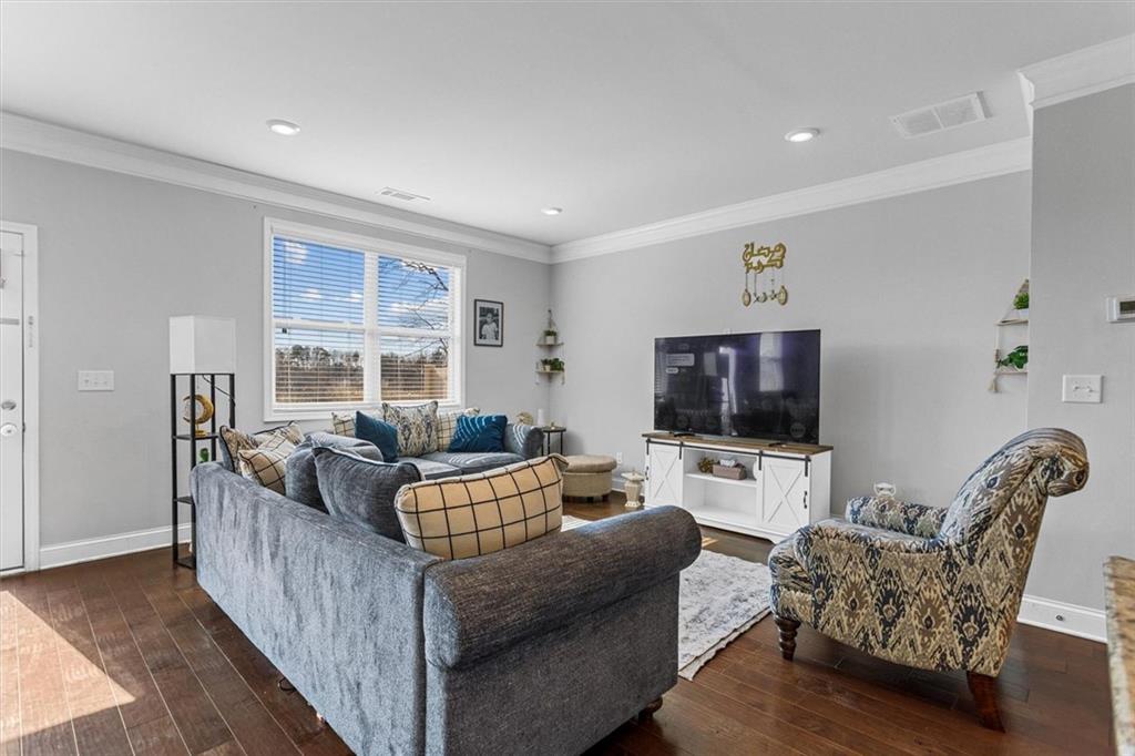 2787 Pearl Rdg Trace Buford, GA 30519 - Photo 28 of 52 a living room with furniture and a flat screen tv