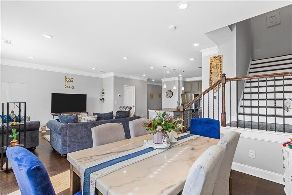 2787 Pearl Rdg Trace Buford, GA 30519 - Photo 35 of 52 a living room with furniture a flat screen tv and a table