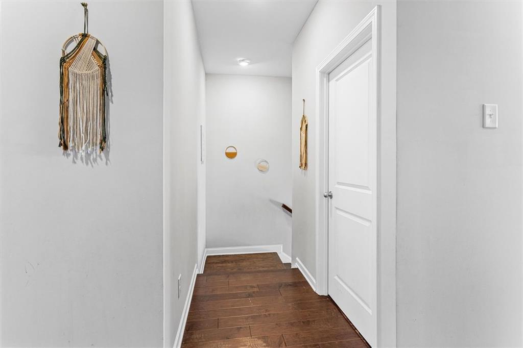 2787 Pearl Rdg Trace Buford, GA 30519 - Photo 37 of 52 a view of a hallway with wooden floor and staircase