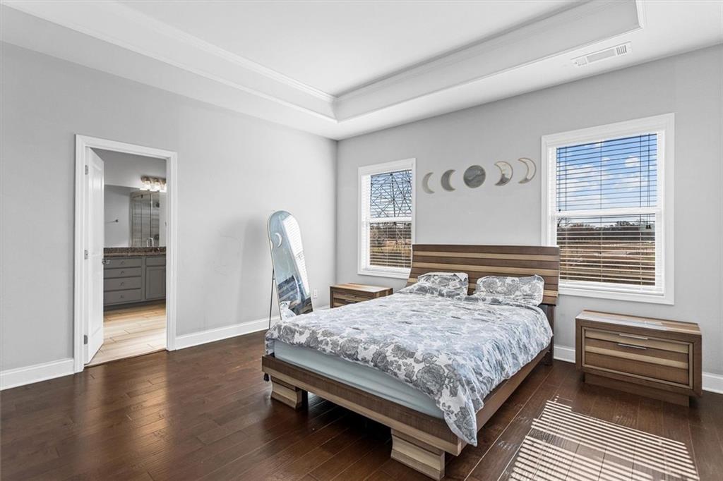 2787 Pearl Rdg Trace Buford, GA 30519 - Photo 41 of 52 a bedroom with a bed and wooden floor